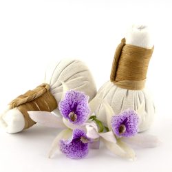 herbal compress with orchid flower on white background